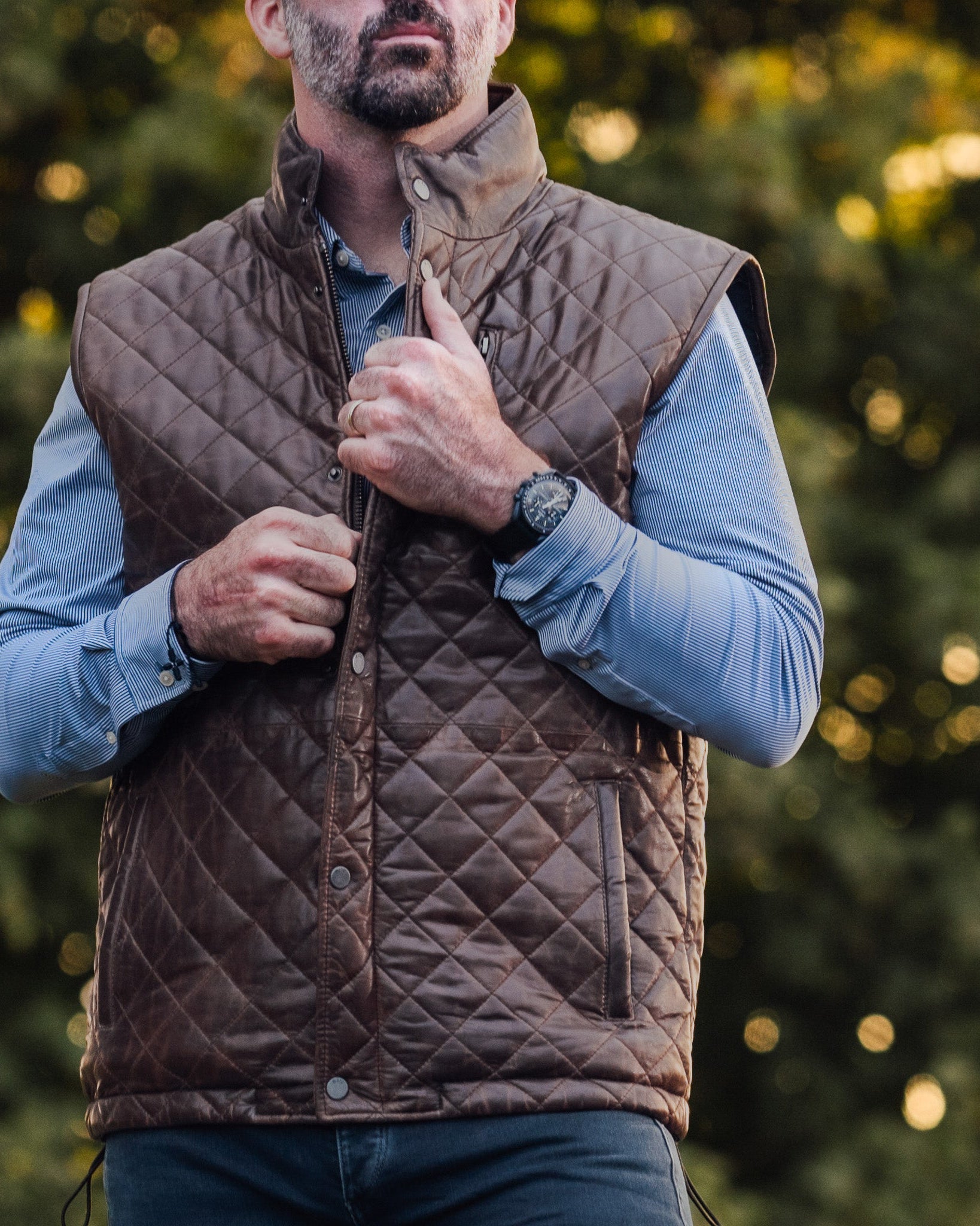 Stylish brown leather vest with a diamond quilt pattern and multiple pockets.