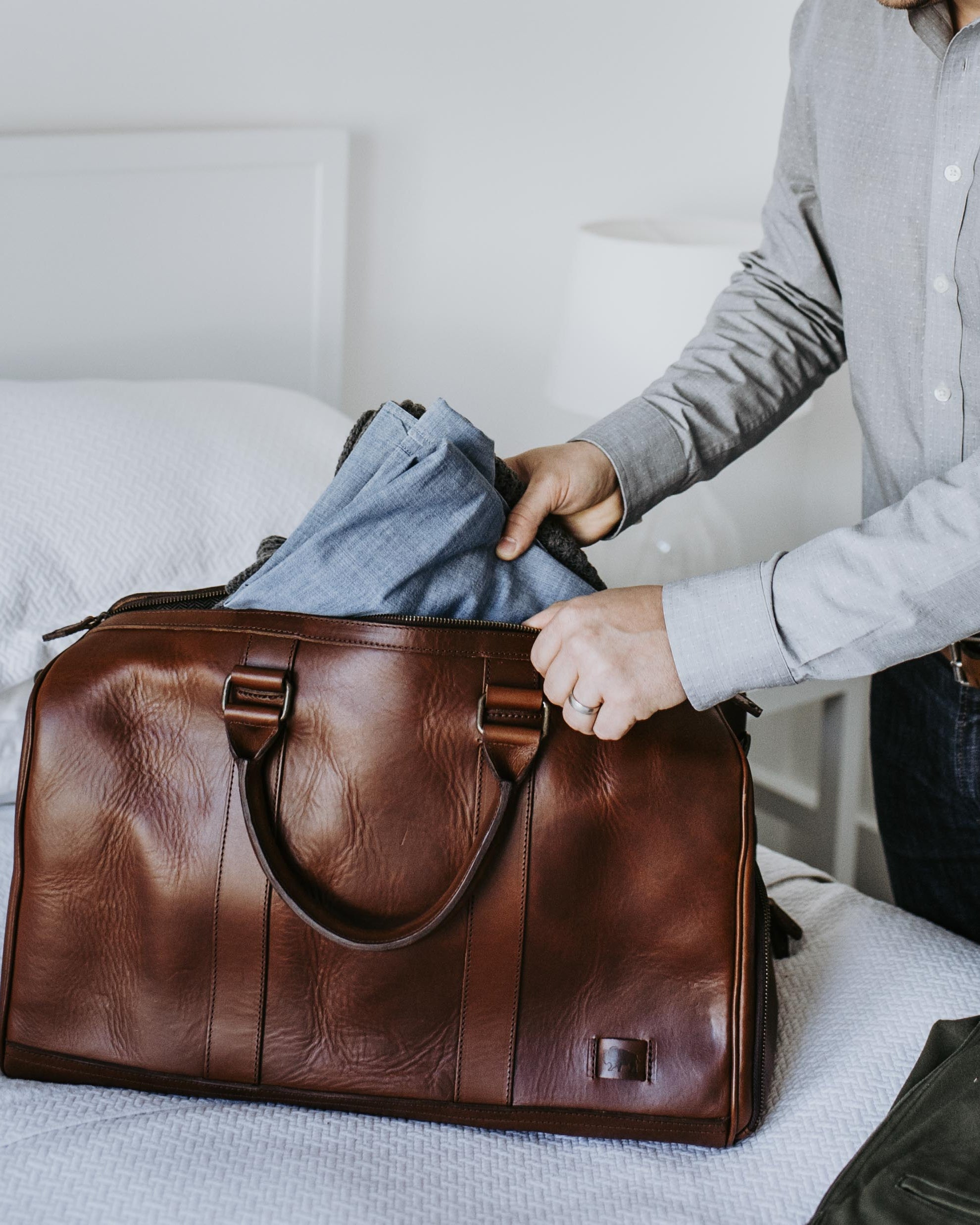 Sophisticated leather carryall, ideal for travel, with ample space, secure zippers, and a timeless design.