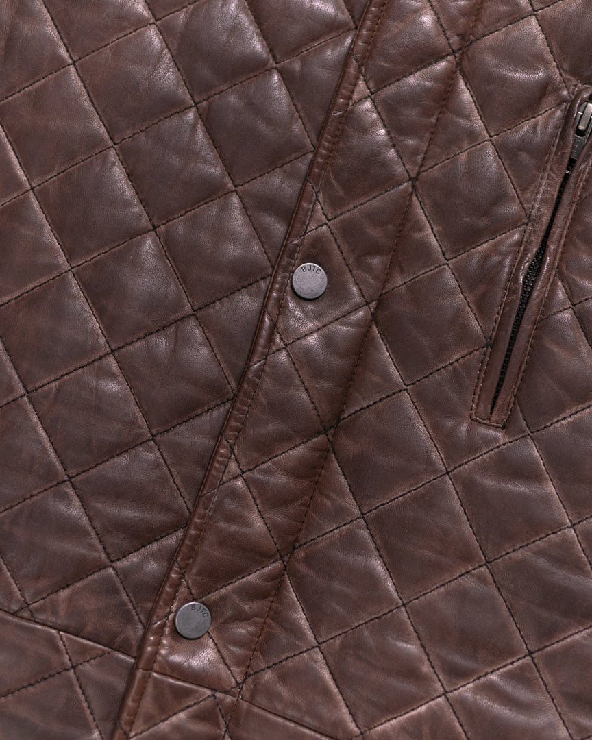 Brown leather vest with a quilted pattern, featuring snap buttons and a sleek silhouette.